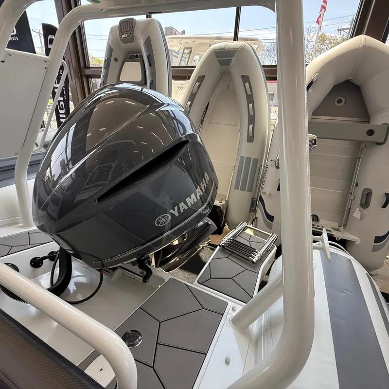 Slide: The Image of Highfield Sport 700 boat storage compartment with blue cooler, 2025 model. - 24