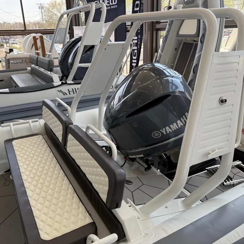 Slide: The Image of 2025 Highfield Sport 700 boat interior with modern steering console and seating. - 3