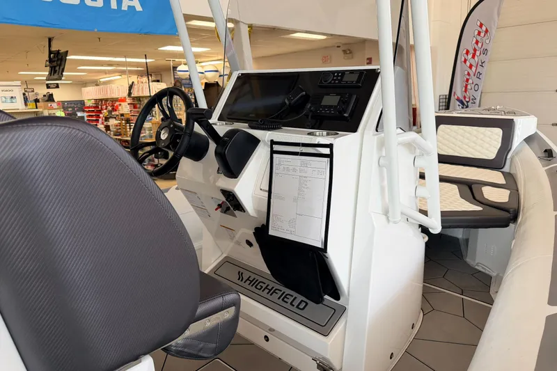 Slide: The Image of 2025 Highfield Sport 700 boat interior with steering console and seating. - 30