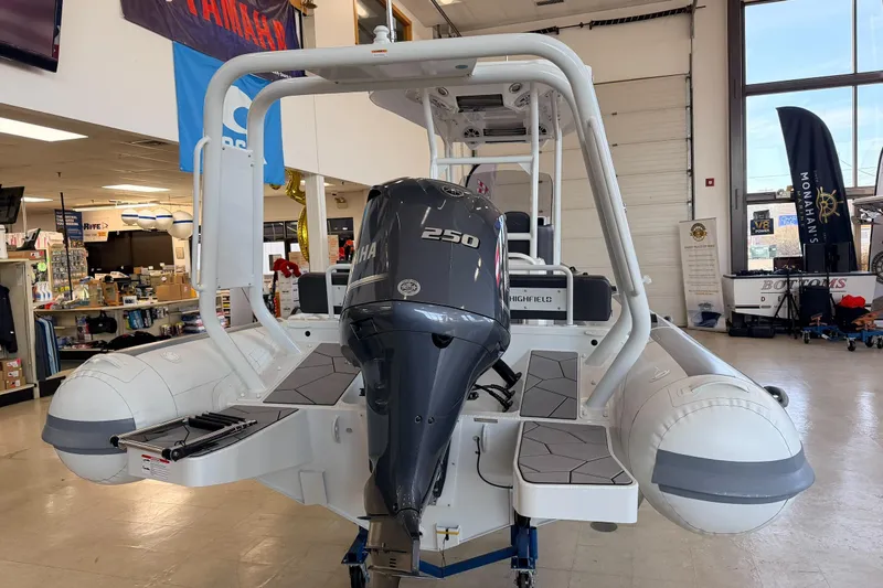 Slide: The Image of 2025 Highfield Sport 700 boat with Yamaha 250 engine displayed indoors. - 33
