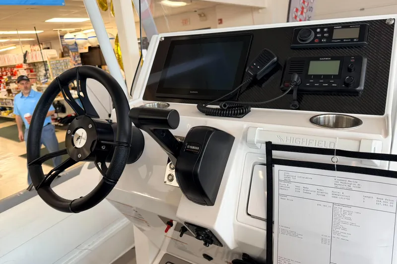 Slide: The Image of Highfield Sport 700 boat dashboard with steering wheel and navigation equipment, 2025 model. - 38
