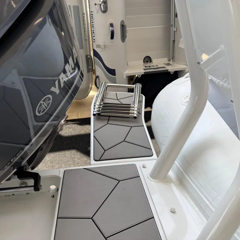 Slide: The Image of 2025 Highfield Sport 700 boat with Yamaha engine, featuring quilted seating and modern design. - 4