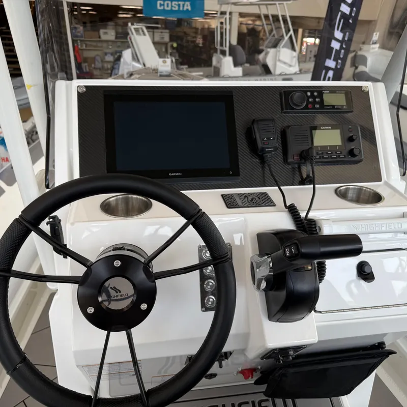 Slide: The Image of Interior of 2025 Highfield Sport 700 boat, featuring dual seats and steering wheel. - 8