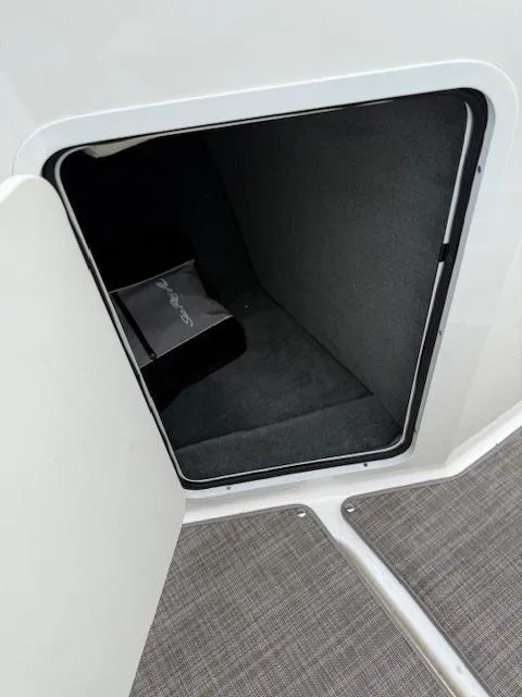 Slide: The Image of Storage compartment in 2018 Sea Ray SPX 190 boat, open door view. - 11