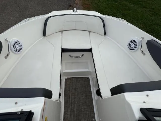 Slide: The Image of 2018 Sea Ray SPX 190 boat interior with white seating and speakers. - 6