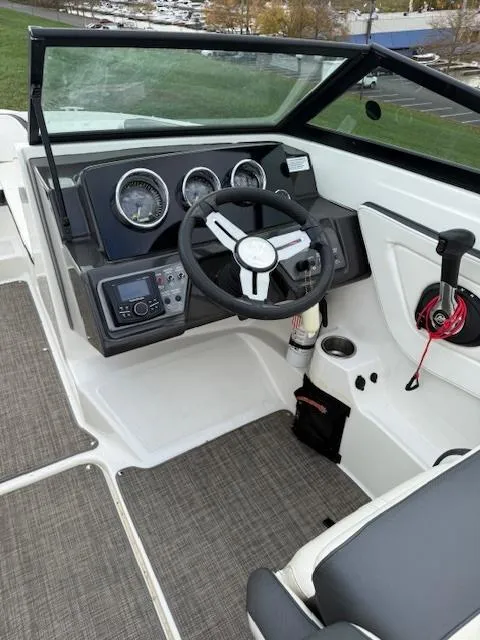 Slide: The Image of 2018 Sea Ray SPX 190 boat interior with steering wheel and dashboard controls. - 7