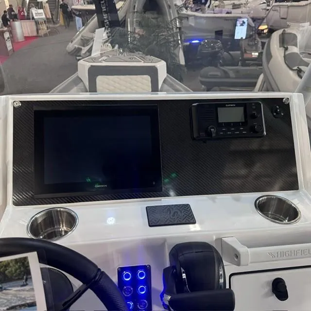 Slide: The Image of Highfield Sport 760 2025 dashboard with touchscreen and controls at a boat show. - 10