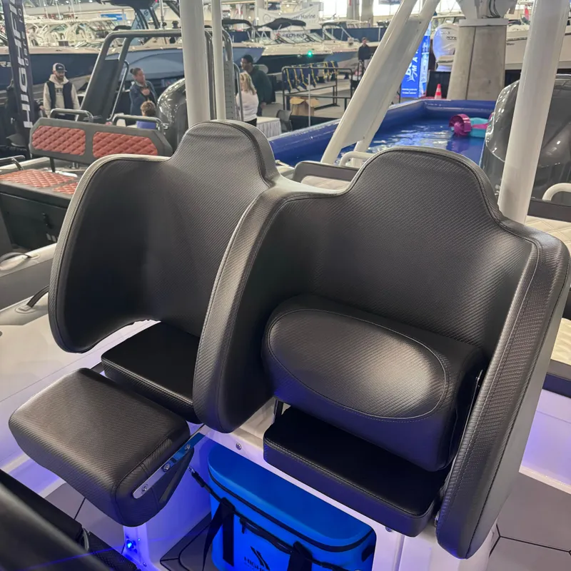 Slide: The Image of Highfield Sport 760 boat seats, 2025 model, at a boat show display. - 14