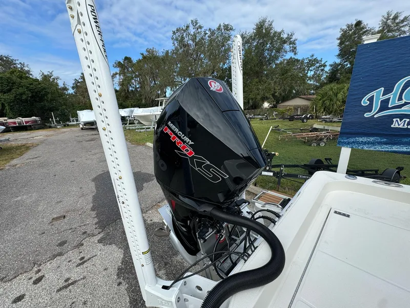 Slide: The Image of 2025 Ranger 2360 Bay boat with powerful outboard motor, docked on a trailer. - 15