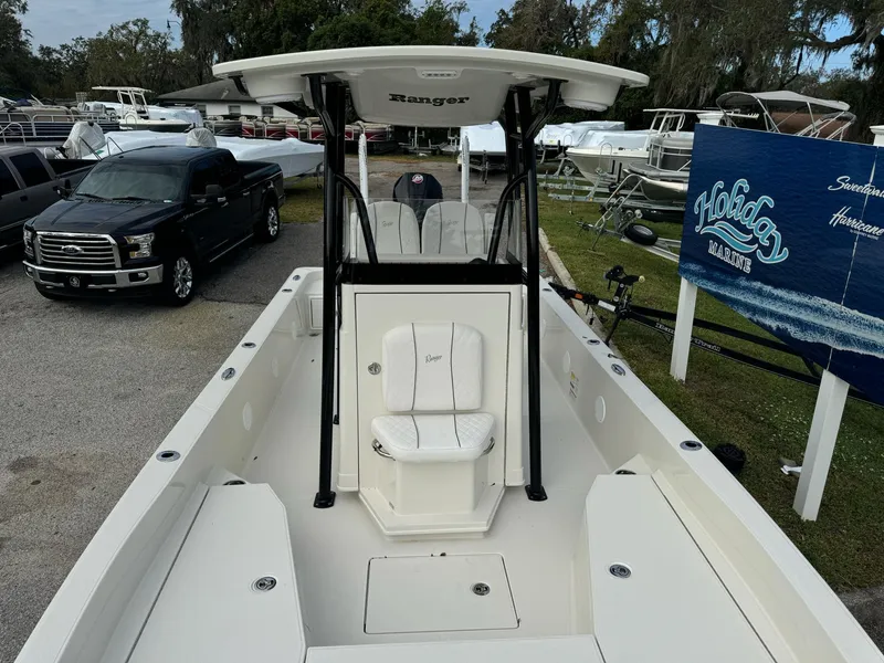 Slide: The Image of 2025 Ranger 2360 Bay boat with T-top, parked near dealership sign. - 17