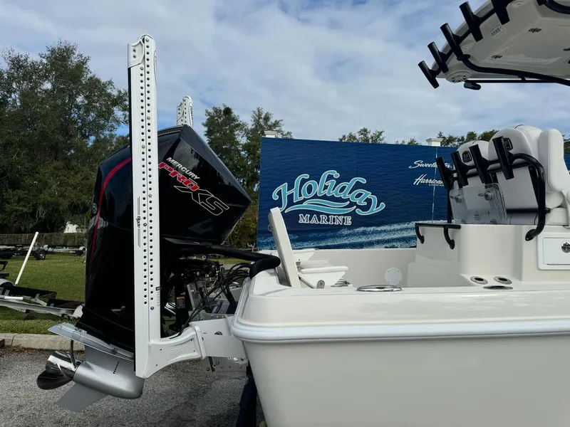 Slide: The Image of 2025 Ranger 2360 Bay boat with sleek design and powerful engine, docked outdoors. - 3