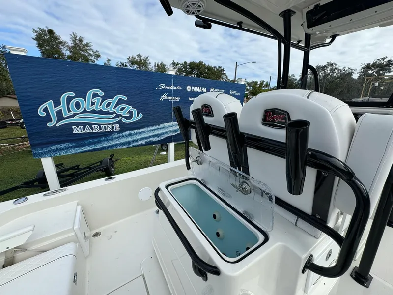 Slide: The Image of 2025 Ranger 2360 Bay boat on trailer, parked outdoors under cloudy sky. - 5