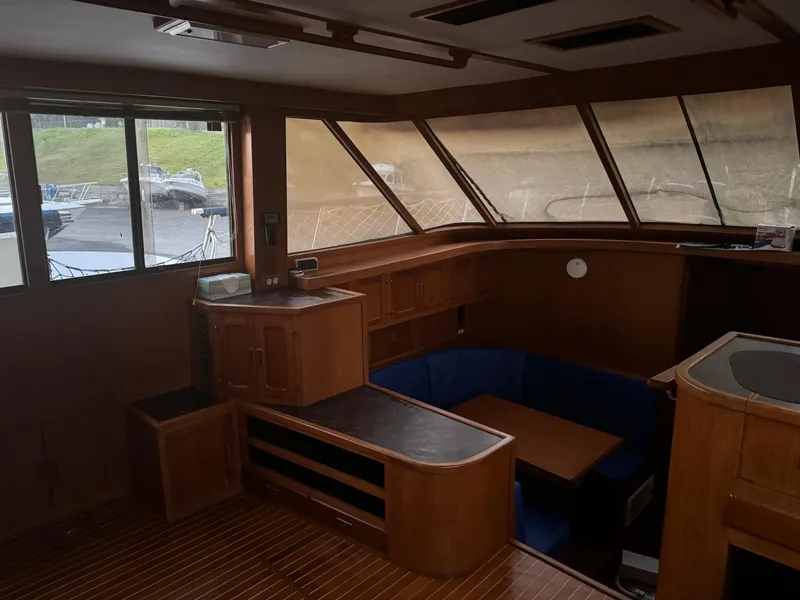 Slide: The Image of Interior of 1988 Vista 43 Motor Yacht with wood paneling and seating area. - 13
