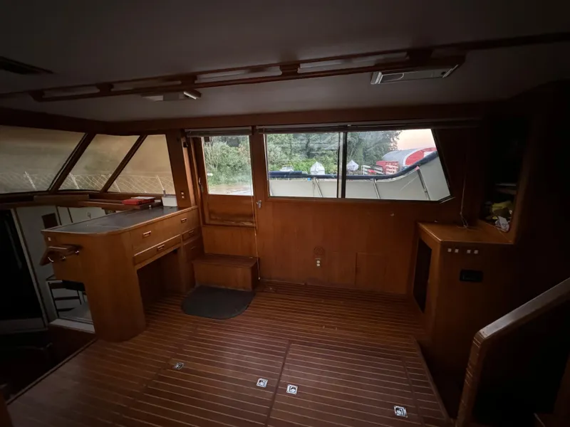 Slide: The Image of Interior of 1988 Vista 43 Motor Yacht with wooden flooring and large windows. - 16