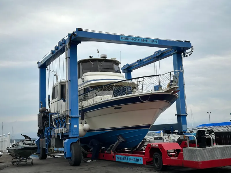 Slide: The Image of 1988 Vista 43 Motor Yacht in dry dock, supported by a blue boat lift. - 2