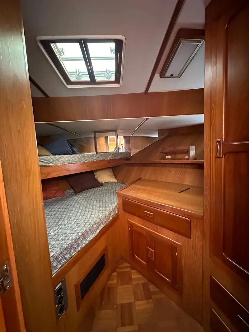 Slide: The Image of 1988 Vista 43 Motor Yacht cabin with wooden interior and bunk beds. - 22