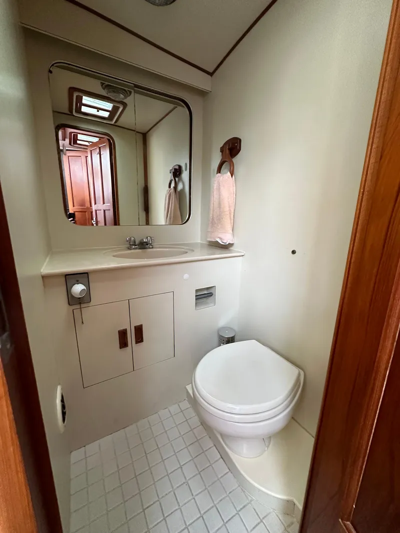 Slide: The Image of 1988 Vista 43 Motor Yacht bathroom with toilet, sink, and mirror. - 25