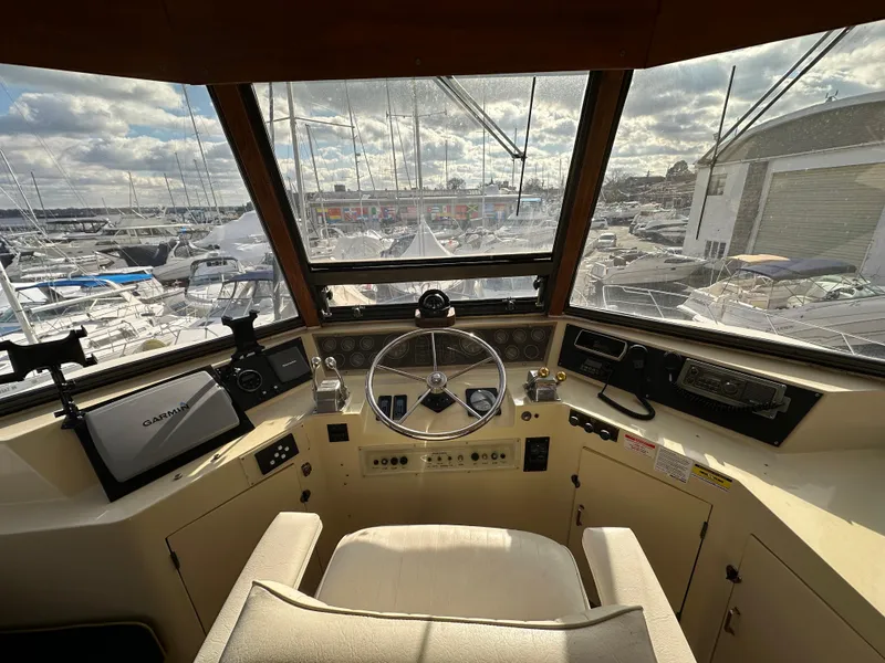 Slide: The Image of Cockpit view of 1988 Vista 43 Motor Yacht with marina in background. - 26