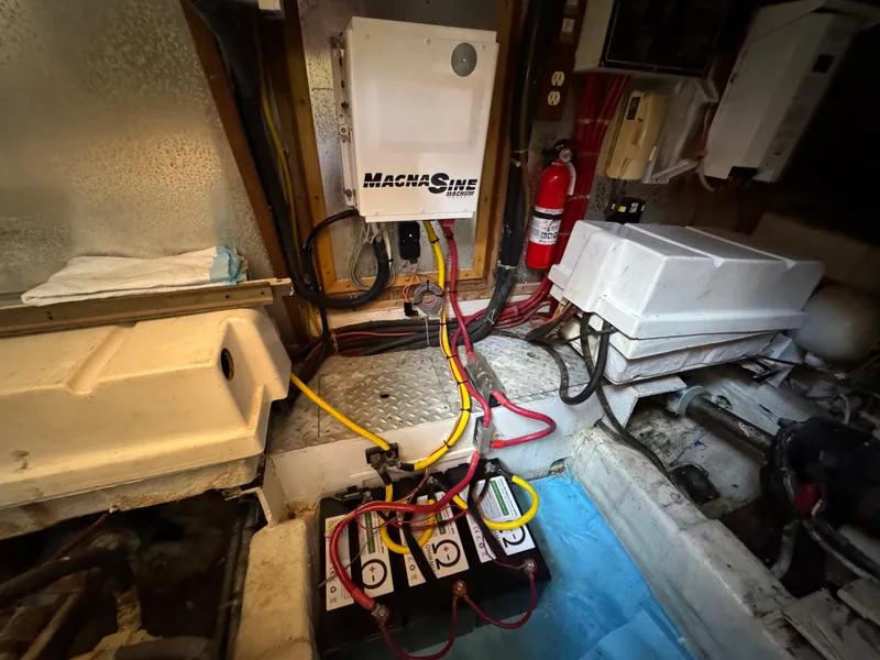 Slide: The Image of Engine room of 1988 Vista 43 Motor Yacht with electrical components and fire extinguisher. - 3