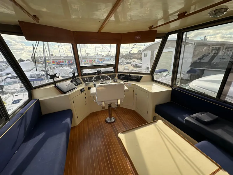 Slide: The Image of Interior of 1988 Vista 43 Motor Yacht with helm, seating, and panoramic windows. - 34