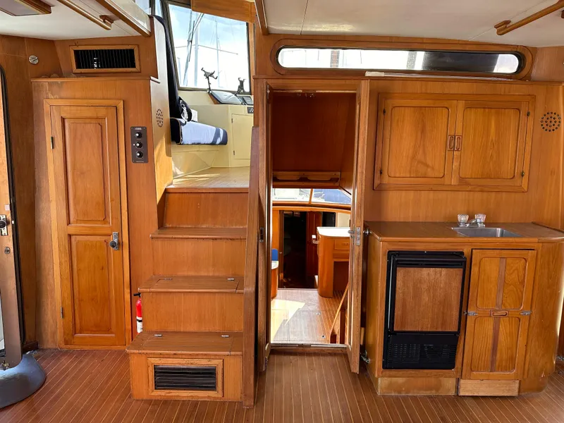 Slide: The Image of 1988 Vista 43 Motor Yacht interior with wooden cabinetry and stairs. - 36