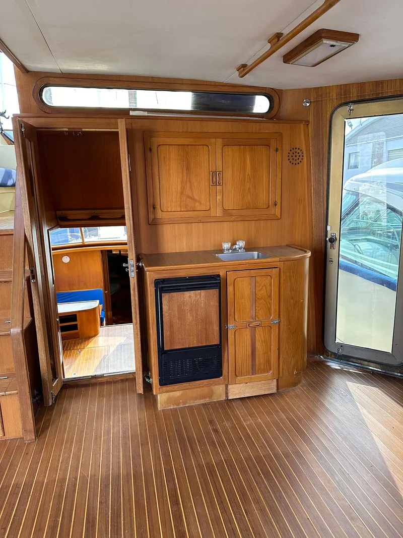 Slide: The Image of Interior of 1988 Vista 43 Motor Yacht with wooden cabinetry and flooring. - 37