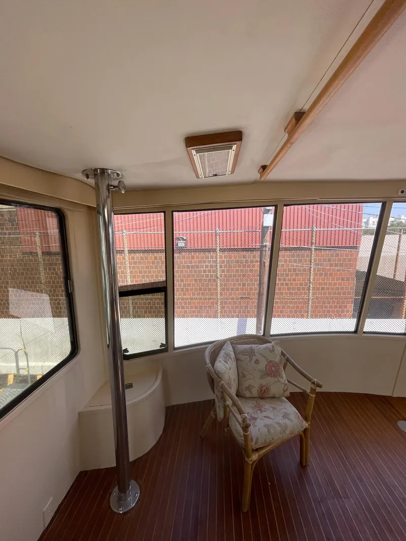 Slide: The Image of Interior of 1988 Vista 43 Motor Yacht with chair and large windows. - 38