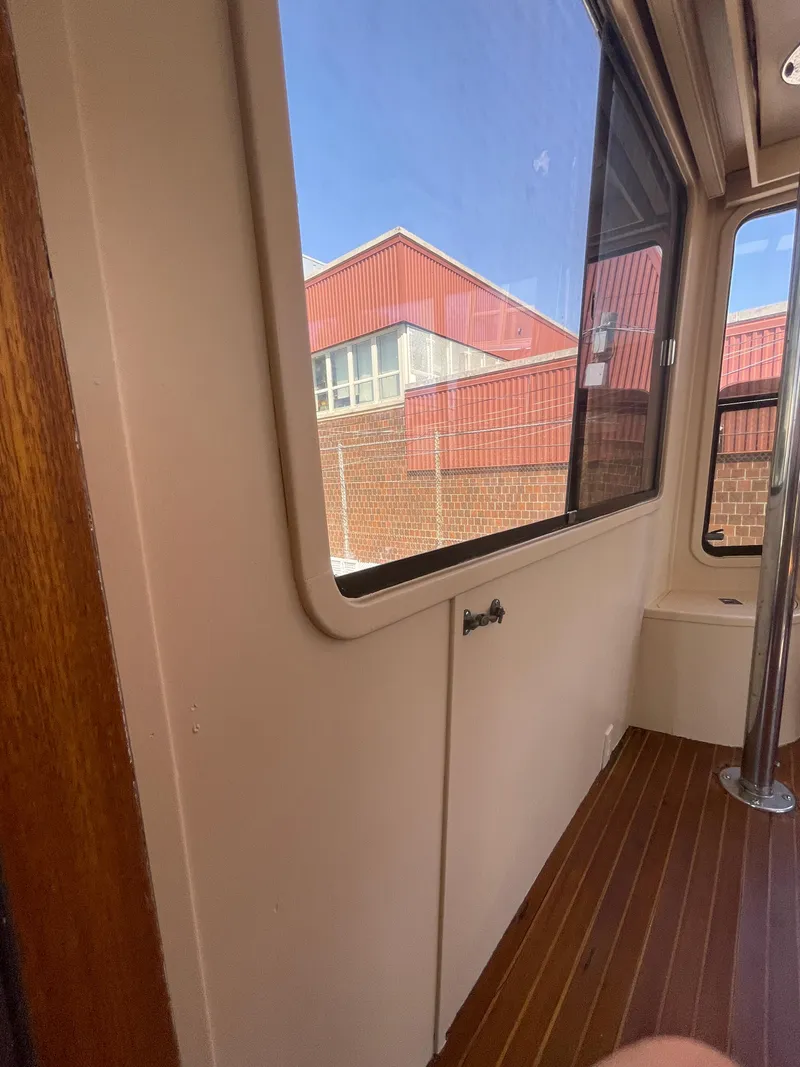 Slide: The Image of Interior view of 1988 Vista 43 Motor Yacht with wooden flooring and large windows. - 40