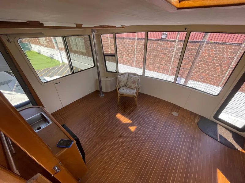 Slide: The Image of Interior of 1988 Vista 43 Motor Yacht with wooden flooring and large windows. - 43