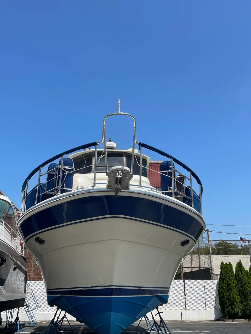 Slide: The Image of 1988 Vista 43 Motor Yacht on stands, viewed from the front under a clear blue sky. - 45