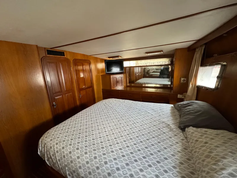 Slide: The Image of Cozy bedroom in 1988 Vista 43 Motor Yacht with wood paneling and a comfortable bed. - 9
