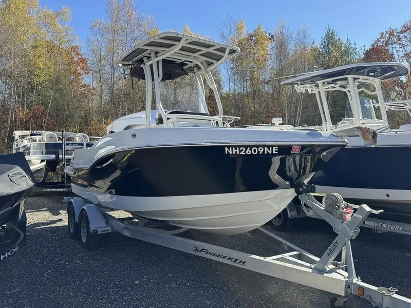 Slide: The Image of 2021 Finseeker 200 FS boat on trailer, surrounded by trees and other boats. - 1