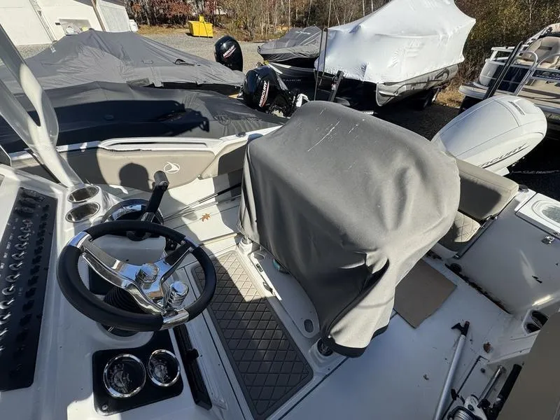 Slide: The Image of 2021 Finseeker 200 FS boat interior with covered seating and steering wheel. - 12