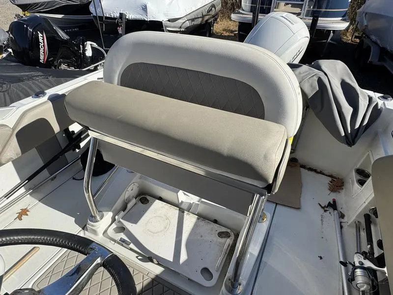 Slide: The Image of 2021 Finseeker 200 FS boat interior with cushioned seating and steering wheel. - 2