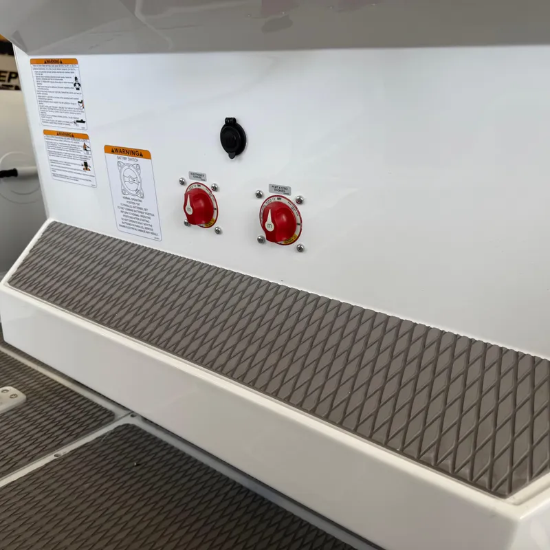 Slide: The Image of Control panel on 2025 Highfield Patrol 860 boat, featuring switches and warning labels. - 12