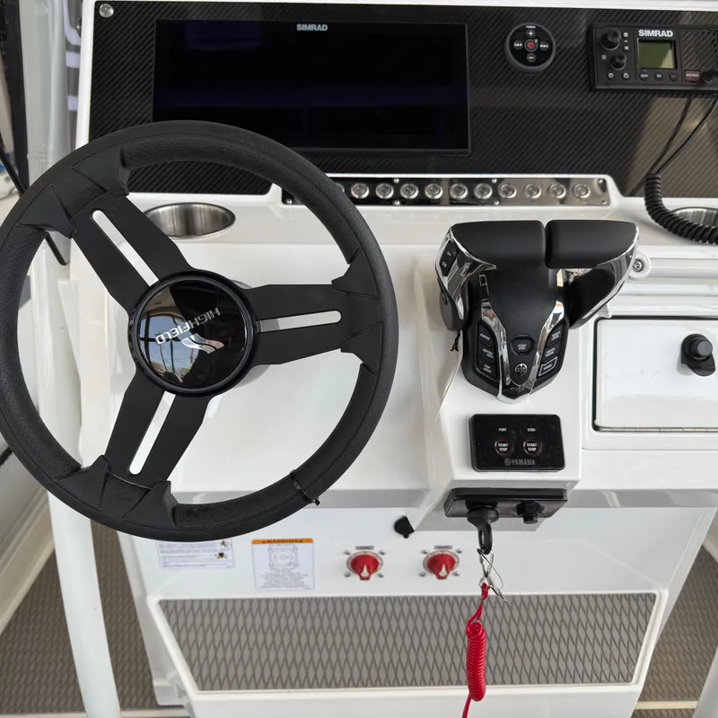 Slide: The Image of Steering console of 2025 Highfield Patrol 860 boat with modern controls and display. - 15