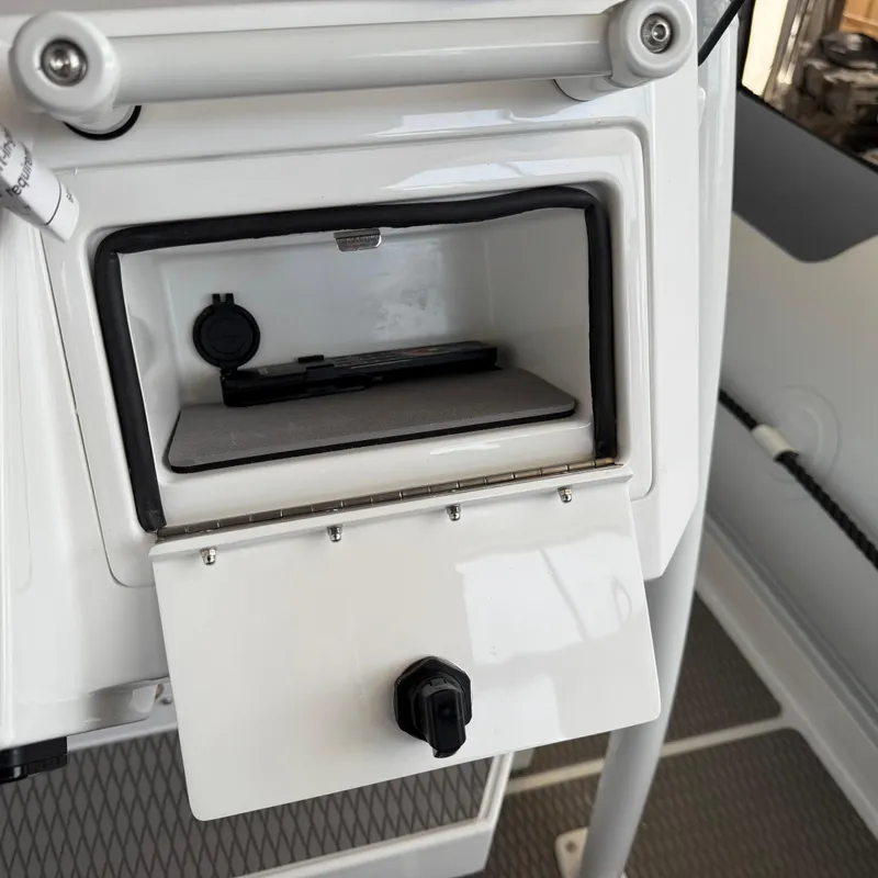 Slide: The Image of Storage compartment on a 2025 Highfield Patrol 860 boat, featuring a secure latch. - 16