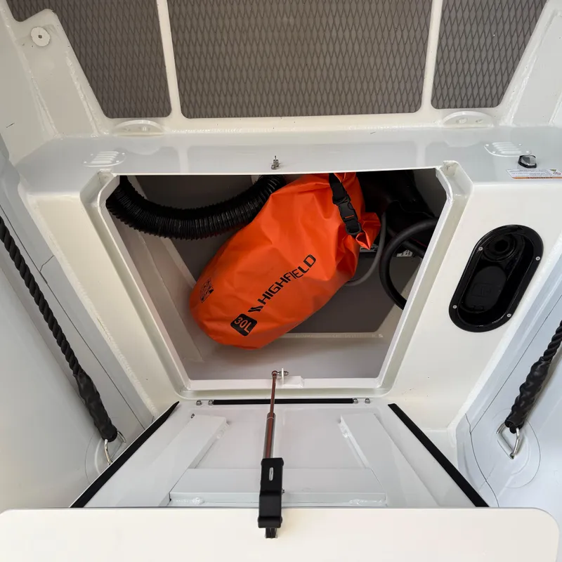 Slide: The Image of Storage compartment of 2025 Highfield Patrol 860 with orange Highfield bag inside. - 19