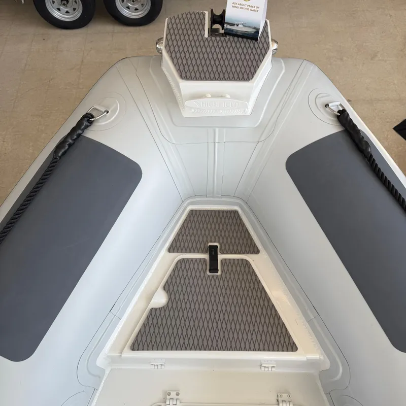 Slide: The Image of 2025 Highfield Patrol 860 boat deck with non-slip surface and rope handles. - 21