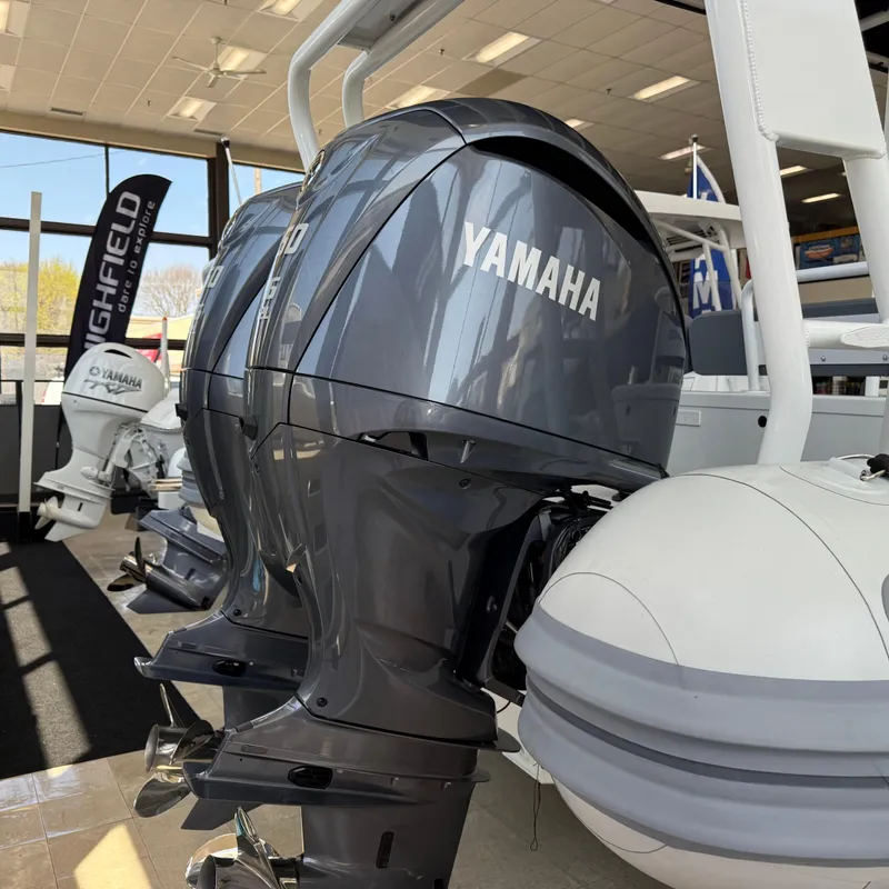 Slide: The Image of 2025 Highfield Patrol 860 with Yamaha outboard engines displayed indoors. - 25