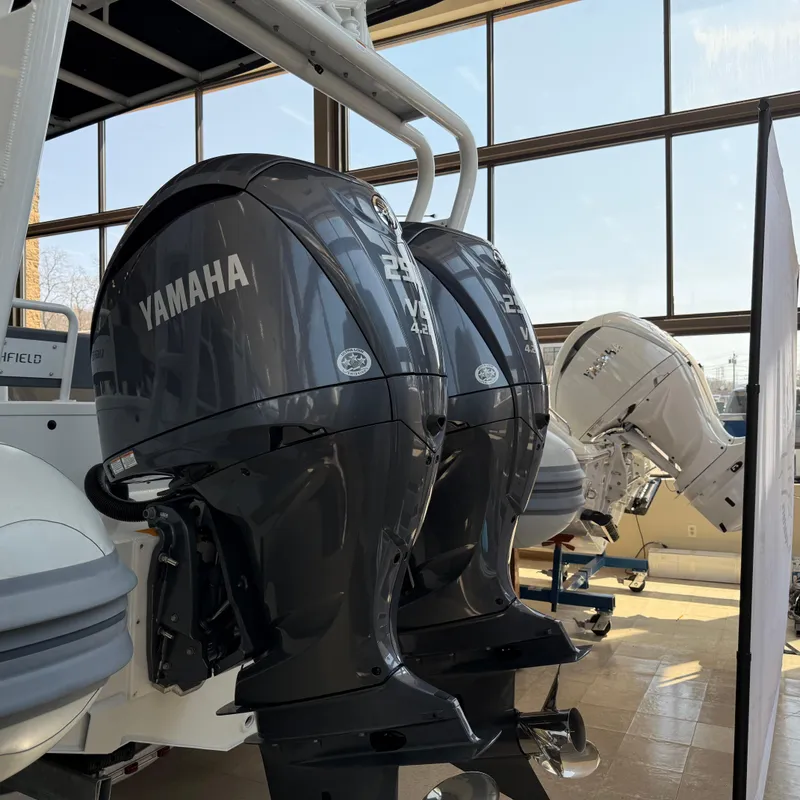 Slide: The Image of 2025 Highfield Patrol 860 with Yamaha outboard engines displayed indoors. - 26