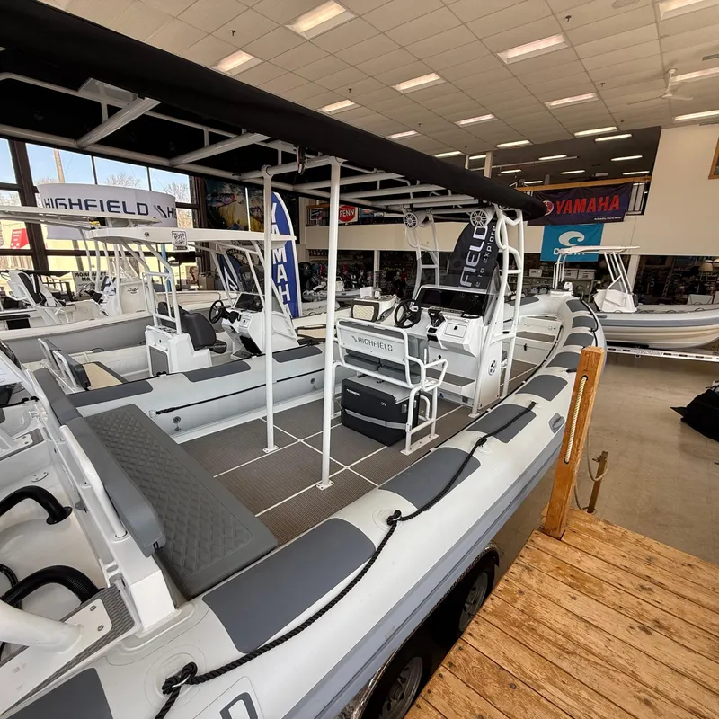 Slide: The Image of 2025 Highfield Patrol 860 boat displayed in a showroom with Yamaha branding. - 3