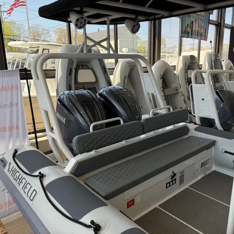 Slide: The Image of 2025 Highfield Patrol 860 boat with Yamaha engines, showcased indoors. - 4