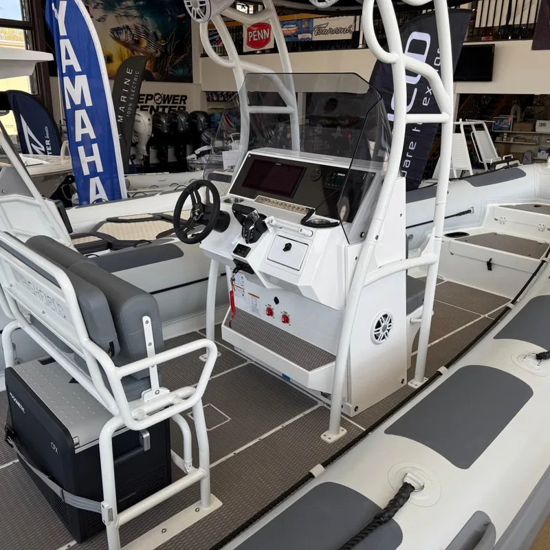 Slide: The Image of 2025 Highfield Patrol 860 boat interior with steering console and seating. - 5