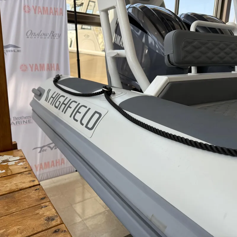 Slide: The Image of 2025 Highfield Patrol 860 boat displayed indoors with Yamaha branding. - 6