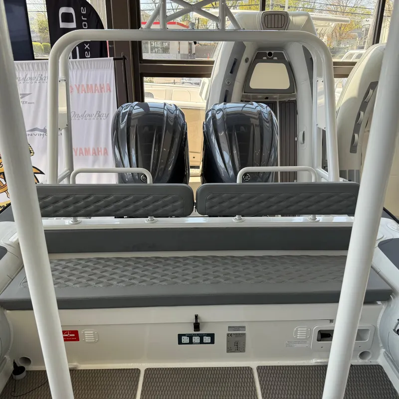 Slide: The Image of 2025 Highfield Patrol 860 boat with dual Yamaha engines, interior view. - 8