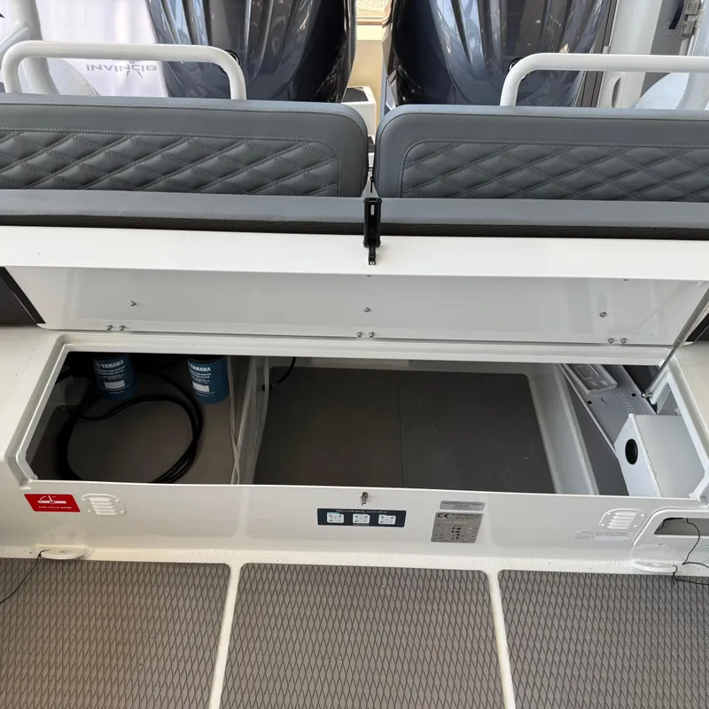 Slide: The Image of 2025 Highfield Patrol 860 boat interior storage compartment with cushioned seating. - 9