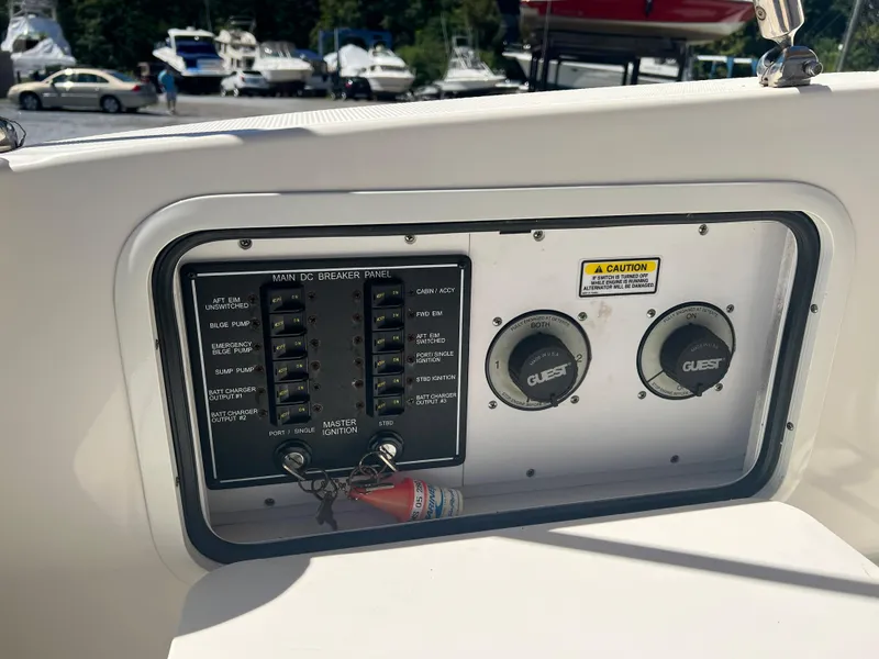 Slide: The Image of Control panel on a 2005 Sea Ray 280 Sundancer boat, featuring switches and gauges. - 13