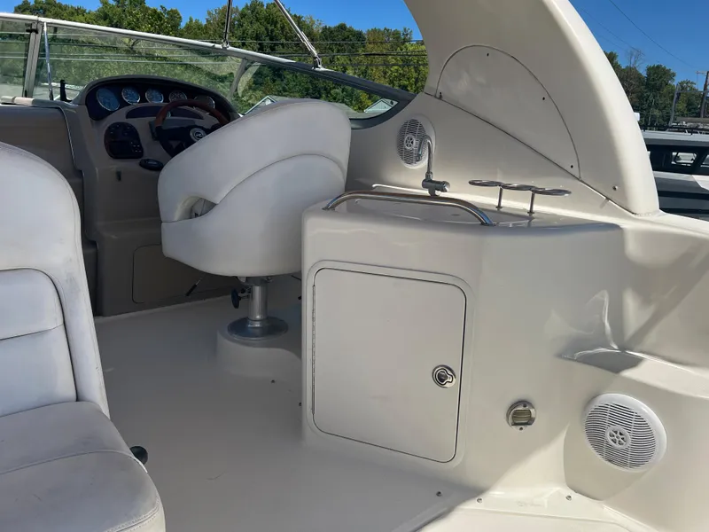 Slide: The Image of 2005 Sea Ray 280 Sundancer boat interior with helm and seating area. - 15