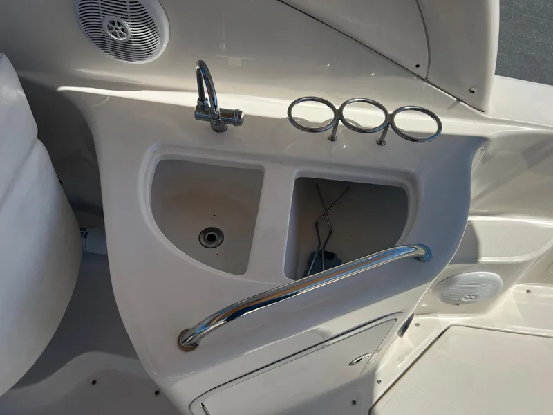 Slide: The Image of 2005 Sea Ray 280 Sundancer boat sink and cup holders in cockpit area. - 16